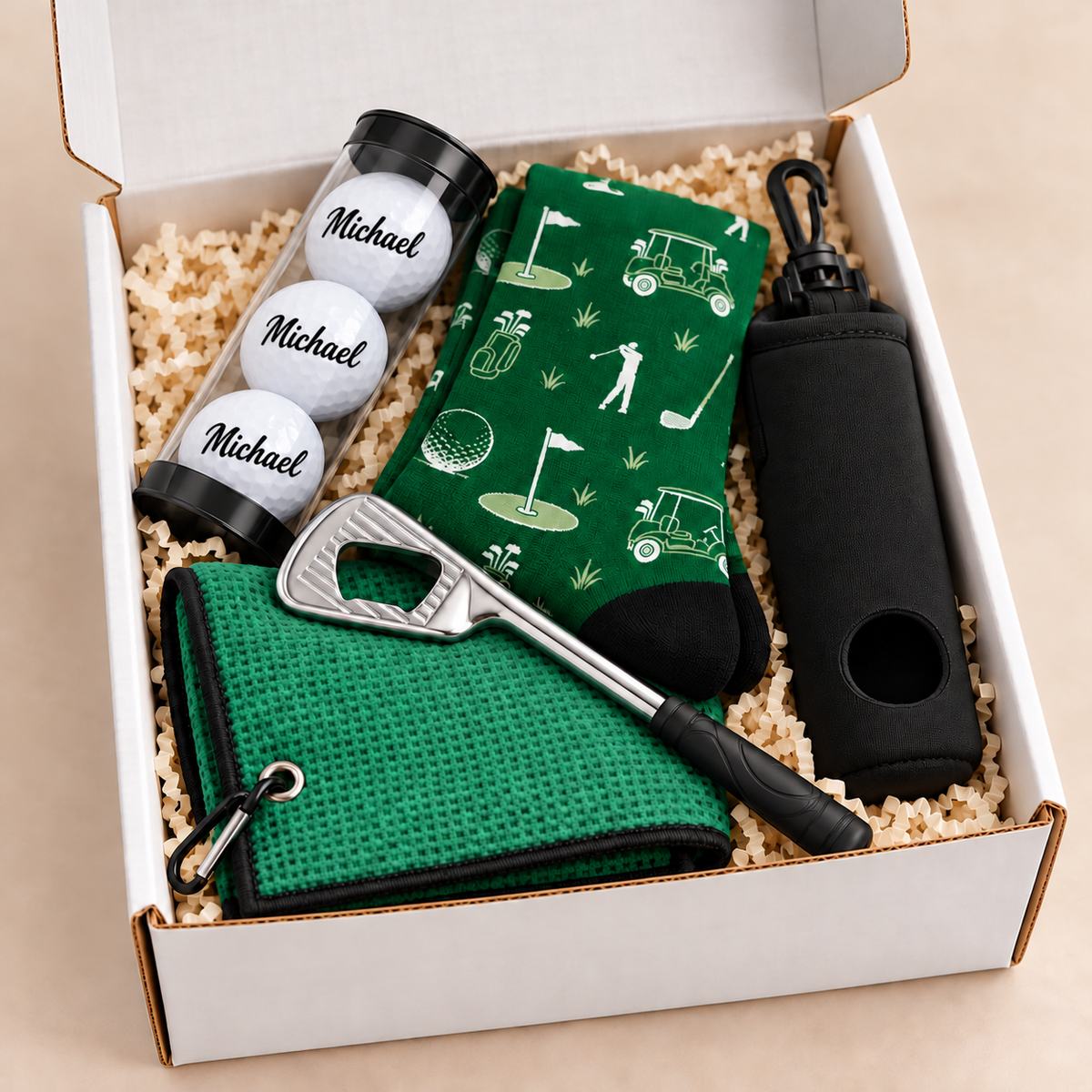 Personalized golfer gift box with custom-name golf balls, green towel, socks, bottle opener and black ball holder