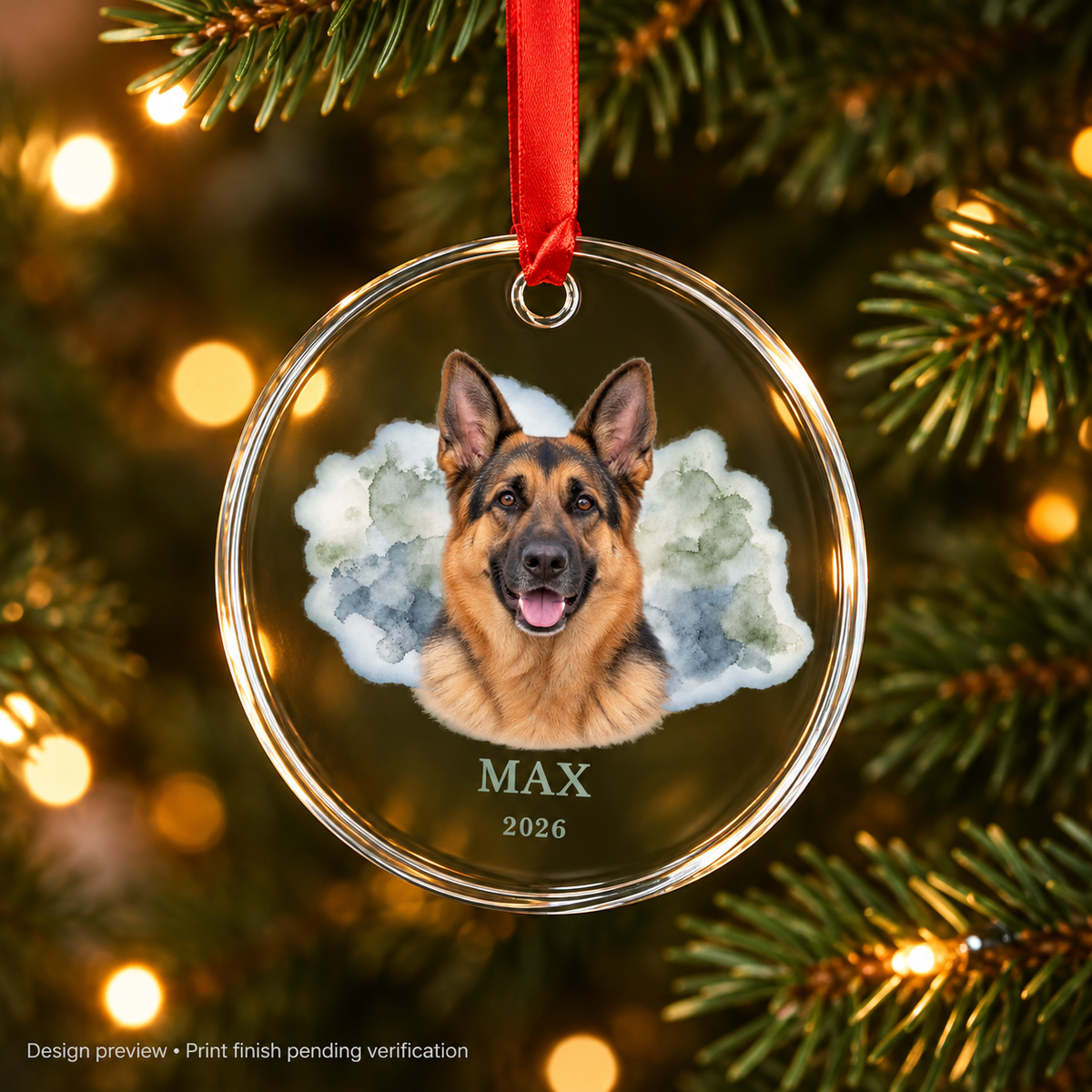 Design preview of Max German Shepherd keepsake glass ornament hanging on a Christmas tree with red ribbon. Print finish pending verification.